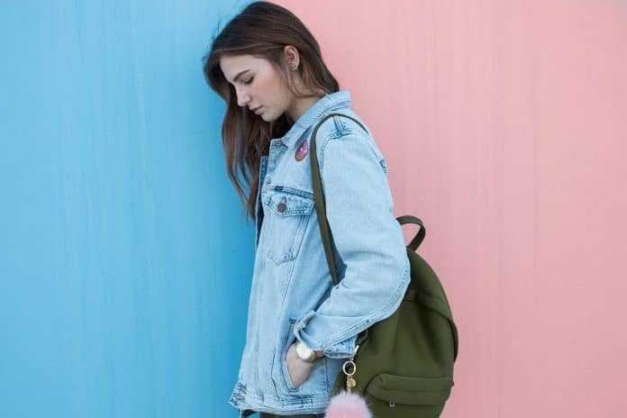 Une jeune fille qui porte une veste en jean